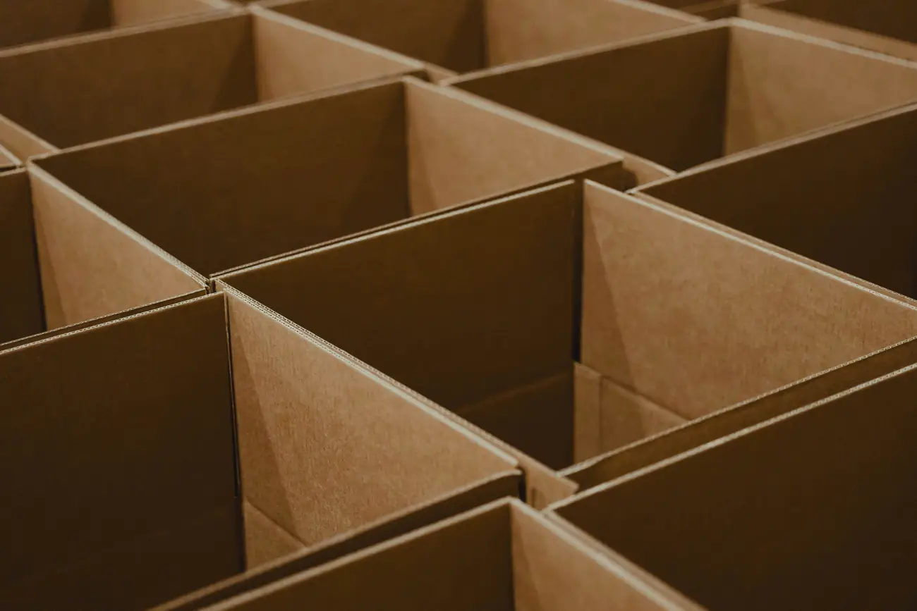 Stacks of open corrugated cardboard shipping boxes ready for one-way packing.