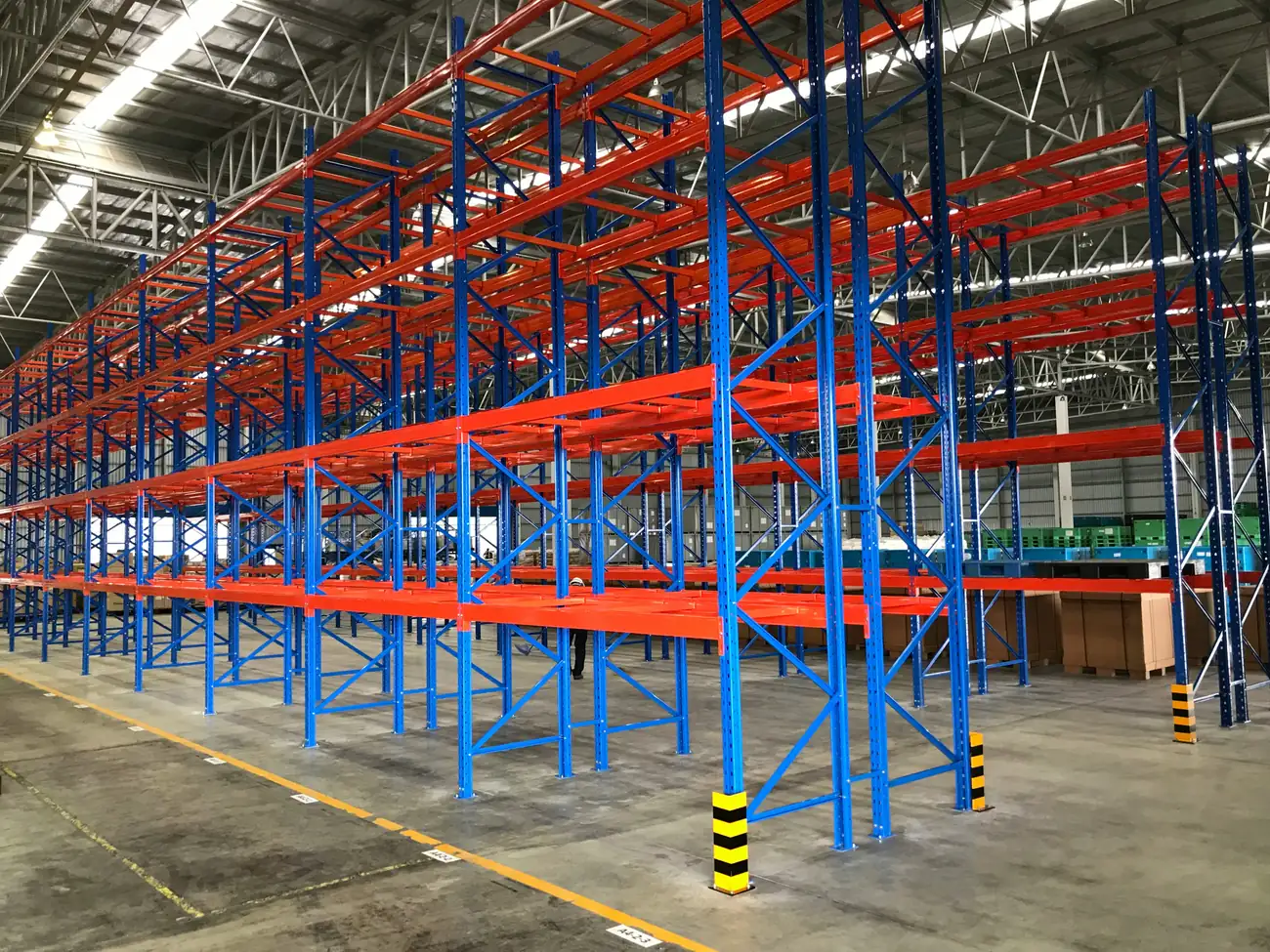 Heavy-duty steel pallet racking system in an industrial warehouse.