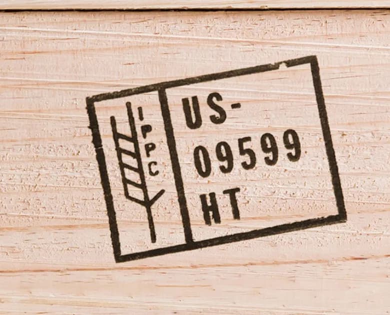 ISPM-15 IPPC heat-treatment stamp (US-09599 HT) branded on an export pallet, certifying compliant heat treatment