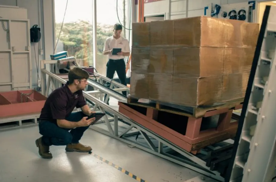 ePallet engineers running a load-stability incline test on a palletized product to validate a pallet redesign and spec